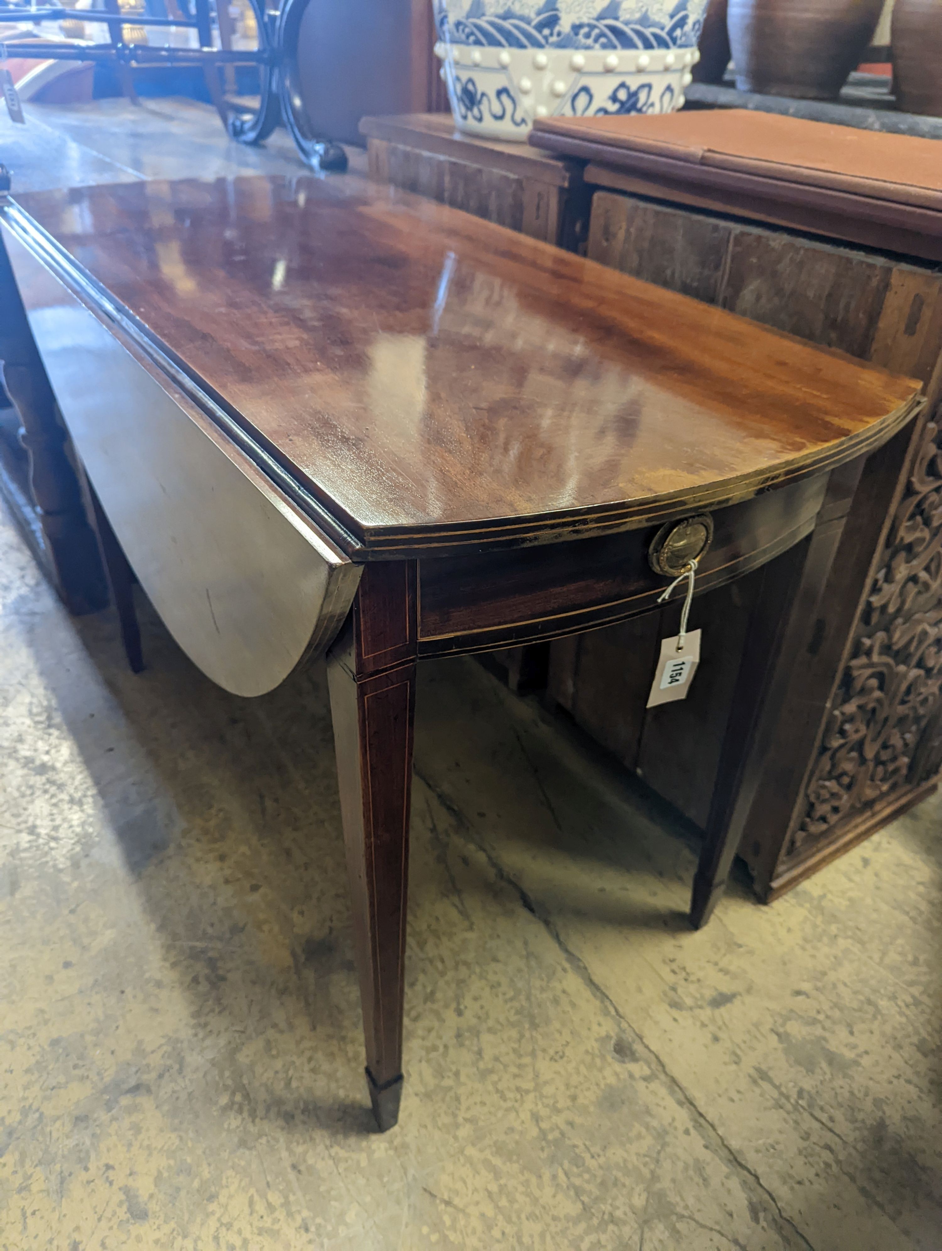 A George III oval mahogany Pembroke table, width 102cm, depth 109cm extended, height 73cm